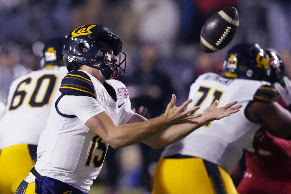 California quarterback Fernando Mendoza (15) bobbles a snap during the first half of the team's Independence Bowl NCAA college football game against Texas Tech, Saturday, Dec. 16, 2023, in Shreveport, La. (AP Photo/Rogelio V. Solis)