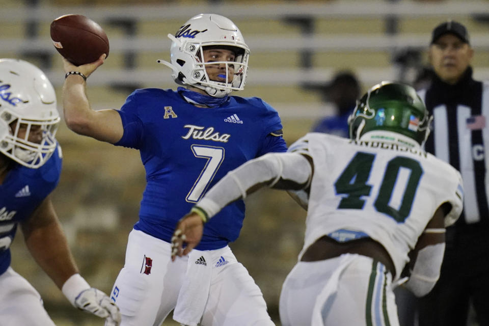 Tulsa quarterback Davis Brin (7) throws a pass while under pressure from Tulane linebacker Nick Anderson (40) during the second half of an NCAA college football game in Tulsa, Okla., Thursday, Nov. 19, 2020. (AP Photo/Sue Ogrocki)