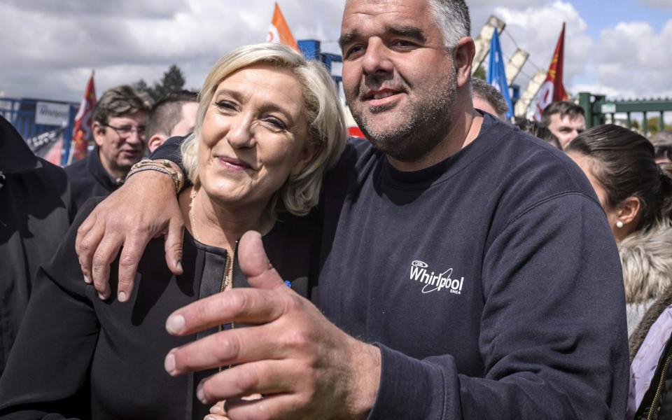 Marine Le Pen (L) poses for photographs with an unidentified supporter (R) and Whirlpool employees outside the Whirlpool plant in Amiens, northern France,  - Credit: CHRISTOPHE PETIT TESSON/EPA