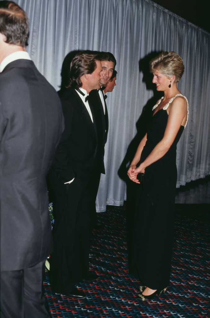<p>The actor chatted with Princess Diana at the premiere of <em>Backdraft </em>in London in a classic tuxedo. The Princess wore a black sleeveless gown with beaded straps designed by Bellville Sassoon. </p>