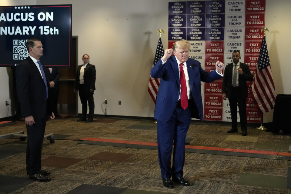 As U.S. Secret Service agents stand their post, former President Donald Trump dances after speaking at a campaign rally at Terrace View Event Center in Sioux Center, Iowa, Friday, Jan. 5, 2024. (AP Photo/Andrew Harnik)