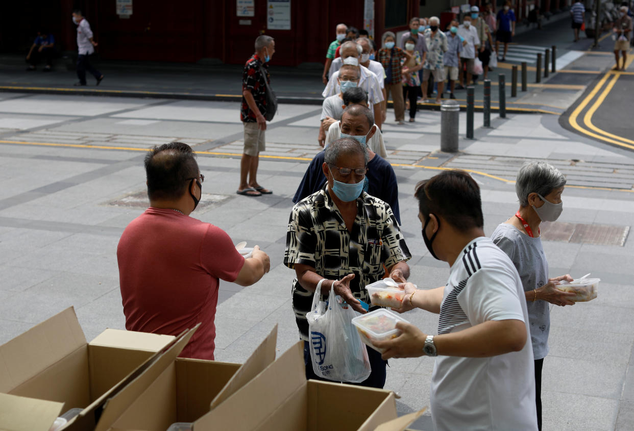 Elderly getting free meals in Chinatown on 17 April 2020. (PHOTO: Reuters)