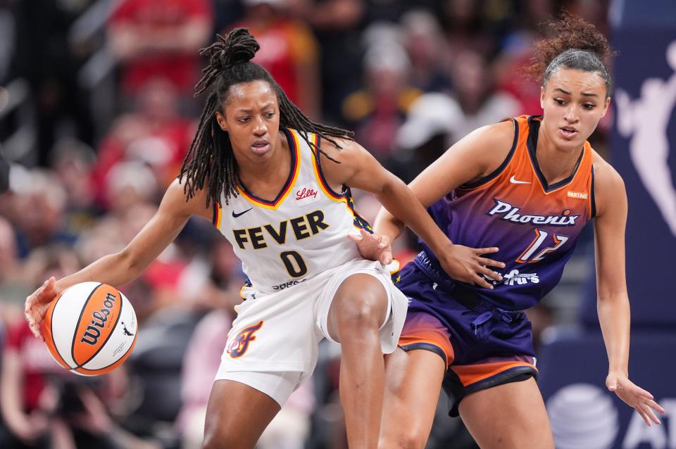 Indiana Fever guard Kelsey Mitchell (0) rushes up the court against Phoenix Mercury Celeste Taylor (12) on Friday, July 12, 2024, during the game at Gainbridge Fieldhouse in Indianapolis. The Indiana Fever defeated the Phoenix Mercury, 95-86.