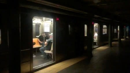 Passengers in a subway train at the 66th Street station during a blackout caused by widespread power outages, in this still frame taken from video, in the Manhattan borough of New York City