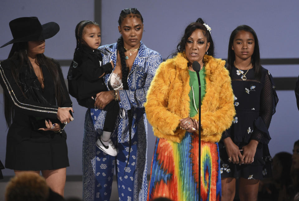 Angelique Smith, mother of late rapper Nipsey Hussle, accepts the humanitarian award on behalf of his son at the BET Awards on Sunday, June 23, 2019, at the Microsoft Theater in Los Angeles. Looking on from background left are Lauren London, Hussle's partner, son Kross, sister Samantha Smith, and daughter Emani Asghedom. (Photo by Chris Pizzello/Invision/AP)