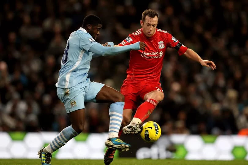 Charlie Adam of Liverpool competes with Kolo Toure of Manchester City during the Barclays Premier League match between Manchester City and Liverpool at the Etihad Stadium on January 3, 2012 in Manchester, England.