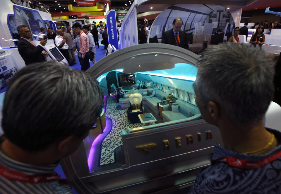 Visitors look into a mock up of a luxury cabin interior on display during the Singapore Airshow at Changi Exhibition Center February 17, 2016. REUTERS/Edgar Su