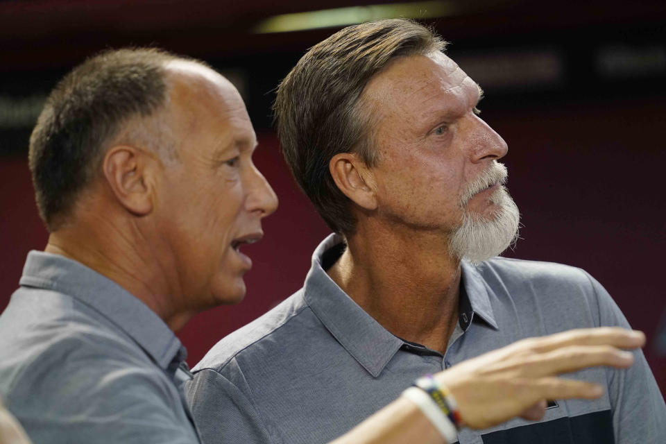 Former Arizona Diamondbacks players Luis Gonzalez, left, and Randy Johnson, watch the video board during the team's 25th anniversary ceremony prior to a baseball game against the San Diego Padres on Saturday, Aug. 12, 2023, in Phoenix. (AP Photo/Matt York)