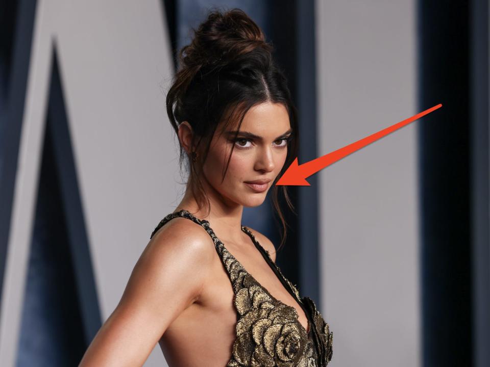 Kendall Jenner with an arrow pointing to her tattoo.