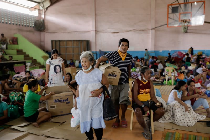 Residents affected by the Taal Volcano eruption remain in an evacuation center in Santo Tomas