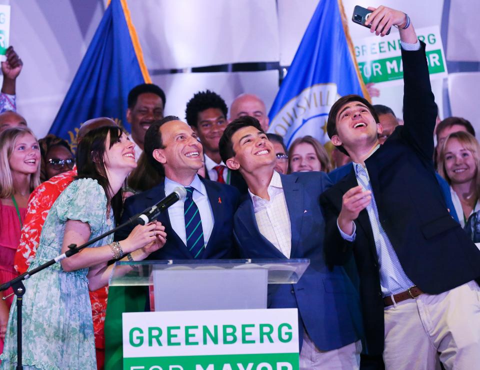 Mayoral candidate Craig Greenberg, second from left, took a selfie with his wife Rachel and their sons  Benjamin, 16, and Daniel, 19, far right, at the C2 Event Venue after winning the Democratic primary election in Louisville, Ky. on May 17, 2022.  