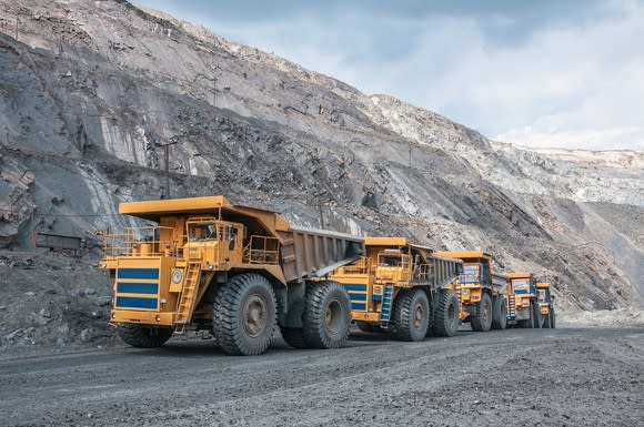 Mining dump trucks in an open-pit mine.