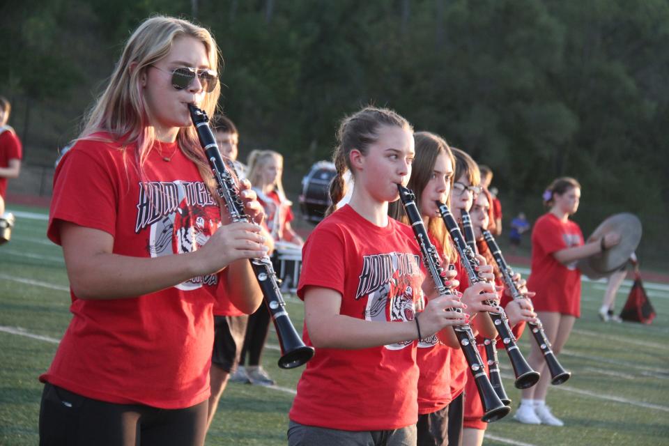 Members of the ADM High School marching band perform the national anthem on Friday, Sept. 8, 2023, at Tiger Stadium in Adel.