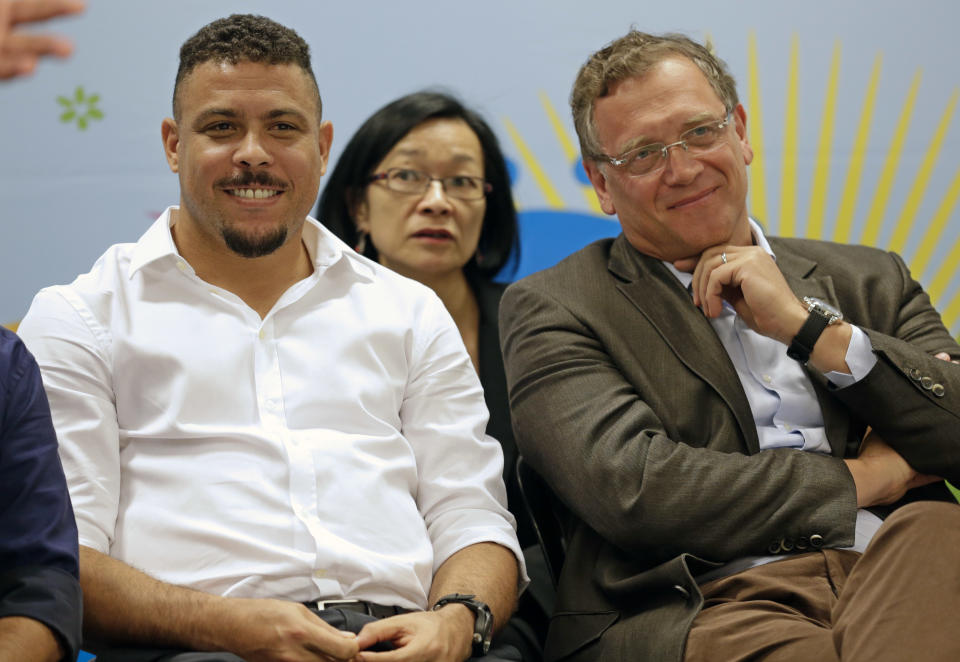 Brazil's former soccer player Ronaldo, left, and FIFA Secretary General Jerome Valcke attend a news conference after inspecting the unfinished Itaquerao stadium in Sao Paulo, Brazil, Tuesday, April 22, 2014. The stadium will host the World Cup opener match between Brazil and Croatia in June 12. (AP Photo/Andre Penner)