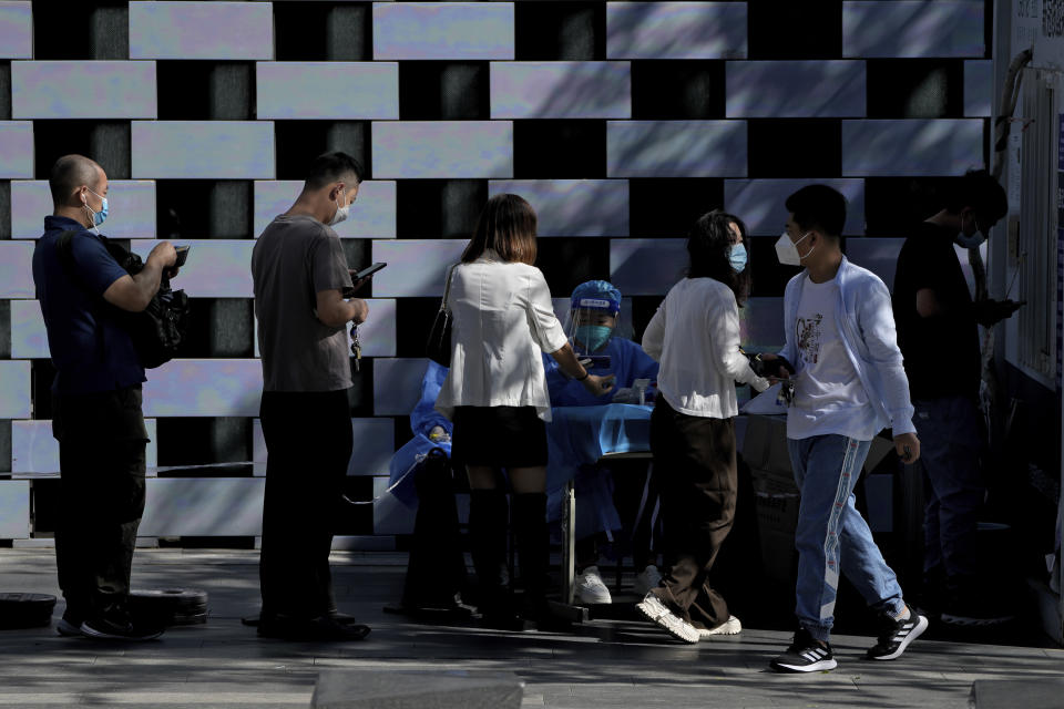 Residents line up to register to get their routine COVID-19 throat swabs at a coronavirus testing site in Beijing, Monday, Sept. 5, 2022. (AP Photo/Andy Wong)