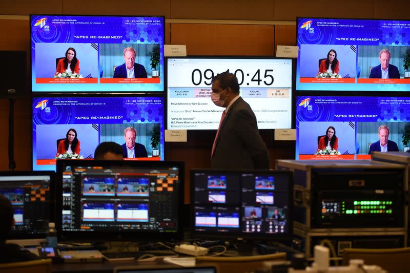 Screens show New Zealand's Prime Minister Jacinda Ardern speaking during the virtual APEC CEO Dialogues 2020, at its command center in Kuala Lumpur