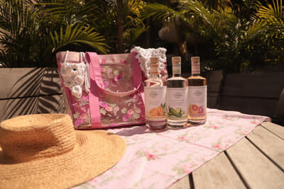 LoveShackFancy Bag and bottles of 21SEEDS displayed on a table