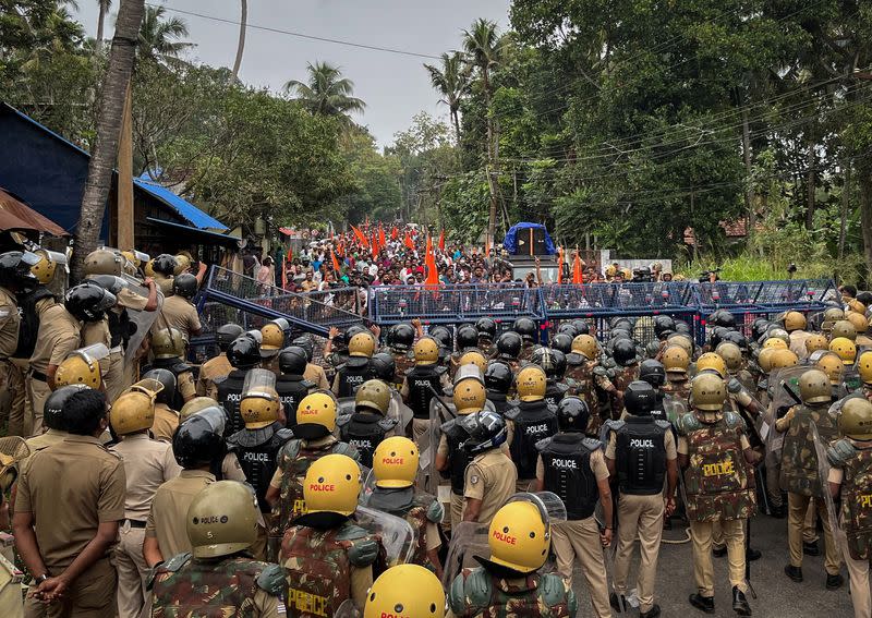 FILE PHOTO: Police officers stand guard near the barricades during a protest rally by the supporters of the proposed Vizhinjam port project