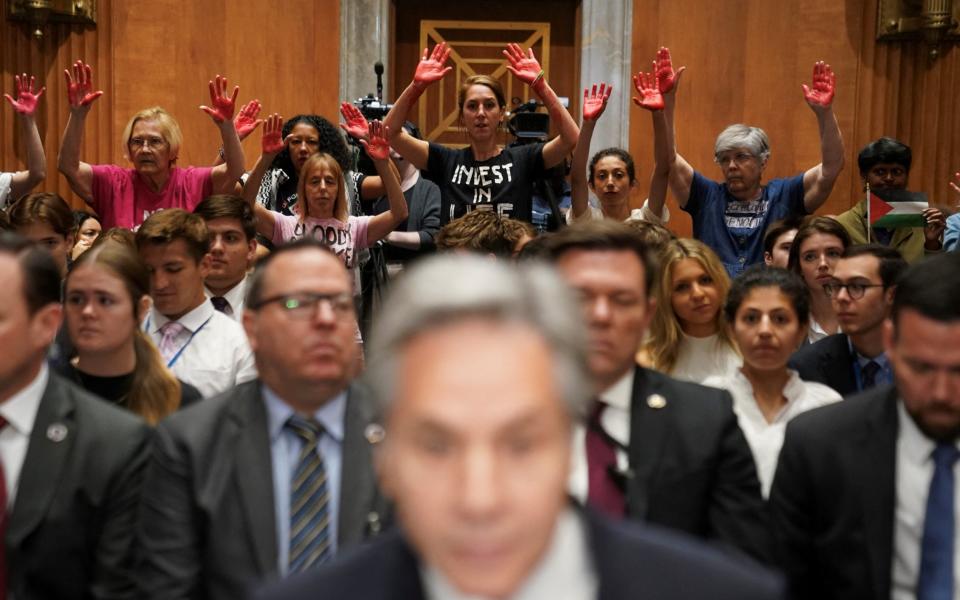 Pro-Palestinian protesters hold up their 'bloody hands'