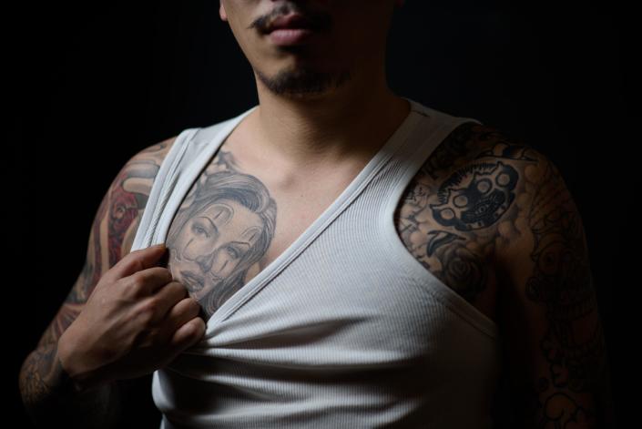 Tattoo artist Horisen, 28, shows off his tattoos at the Tattooism studio in Seoul on December 9, 2014 (AFP Photo/Ed Jones)