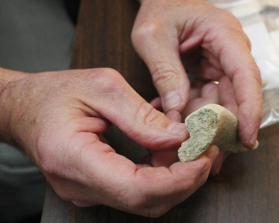 Timothy Matney, University of Akron archaeology professor, holds a piece of a storage vessel dating back to 900-600 B.C. from a dig in the Kurdish region of Iraq. Matney is studying how the regular people lived during that time period.