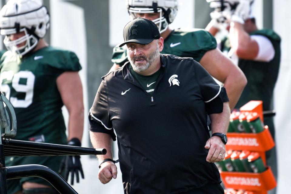 Michigan State's offensive line coach Chris Kapilovic works with players during the opening day of fall camp on Thursday, Aug. 5, 2021, on the MSU campus in East Lansing.