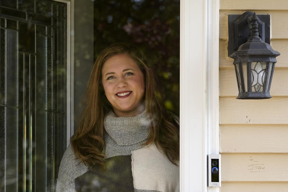 In this Thursday, Oct. 16, 2020, photo undecided voter Rebecca Westrate poses for a photo at her home in Round Lake, Ill. Four years ago, undecided voters’ late support for Donald Trump helped push him to victory. While there are fewer on-the-fence voters this time around, a small but potentially significant group say they remain truly undecided less than three weeks before the November 3 election. (AP Photo/Nam Y. Huh)