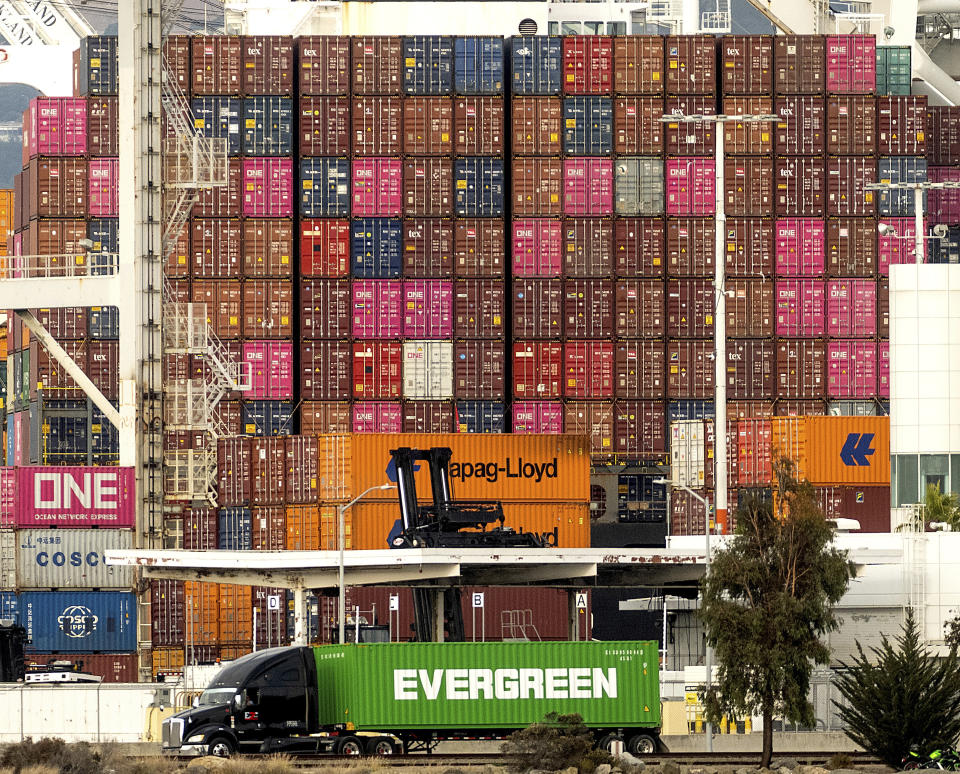 FILE - A truck passes a container ship at the Port of Oakland on Tuesday, Oct. 19, 2021, in Oakland, Calif. California farmers say they are having trouble exporting their crops because of delays in the global supply chain. Intense demand for products has led to a backlog of container ships outside the nation's two largest ports along the Southern California coast. (AP Photo/Noah Berger, File)