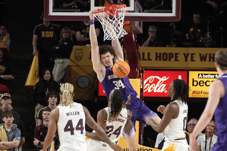 Washington center Braxton Meah (34) dunks in front of Arizona State guard Adam Miller (44), forward Bryant Selebangue (24) and guard Kamari Lands (0) during the second half of an NCAA college basketball game Thursday, Feb. 22, 2024, in Tempe, Ariz. (AP Photo/Darryl Webb)