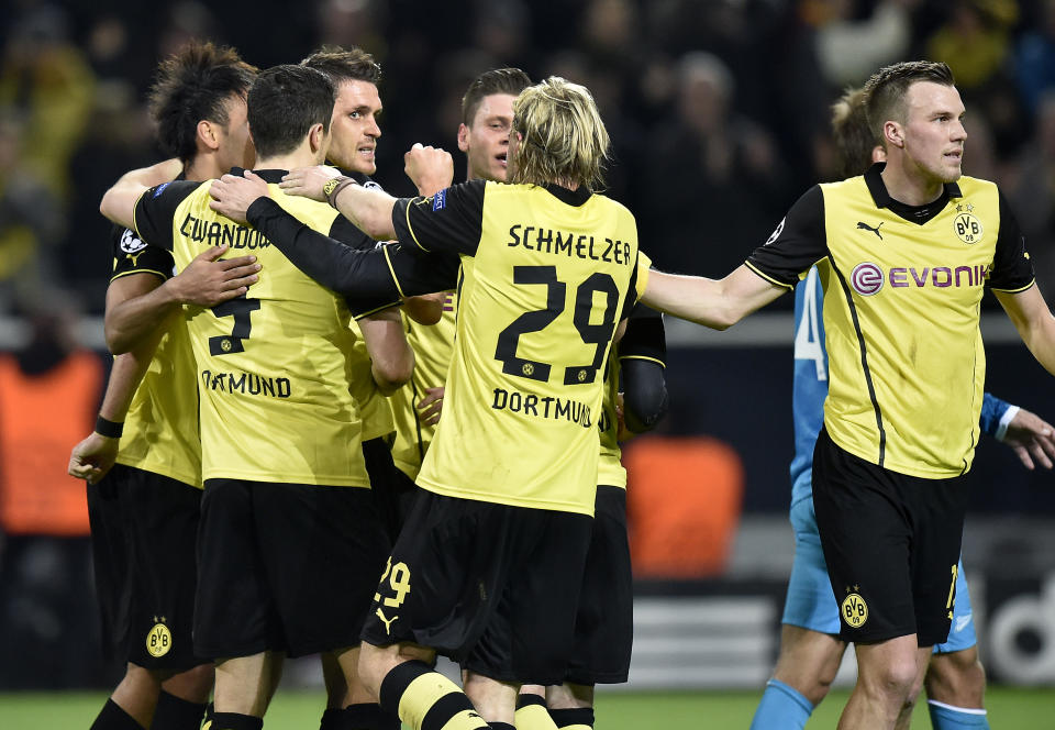 Dortmund's Sebastian Kehl, third left, raises his fist as he celebrates scoring his side's first goal with his teammates during the UEFA Champions League last 16 second leg soccer match between Borussia Dortmund and FC Zenit in Dortmund, Germany, Wednesday, March 19, 2014. (AP Photo/Martin Meissner)