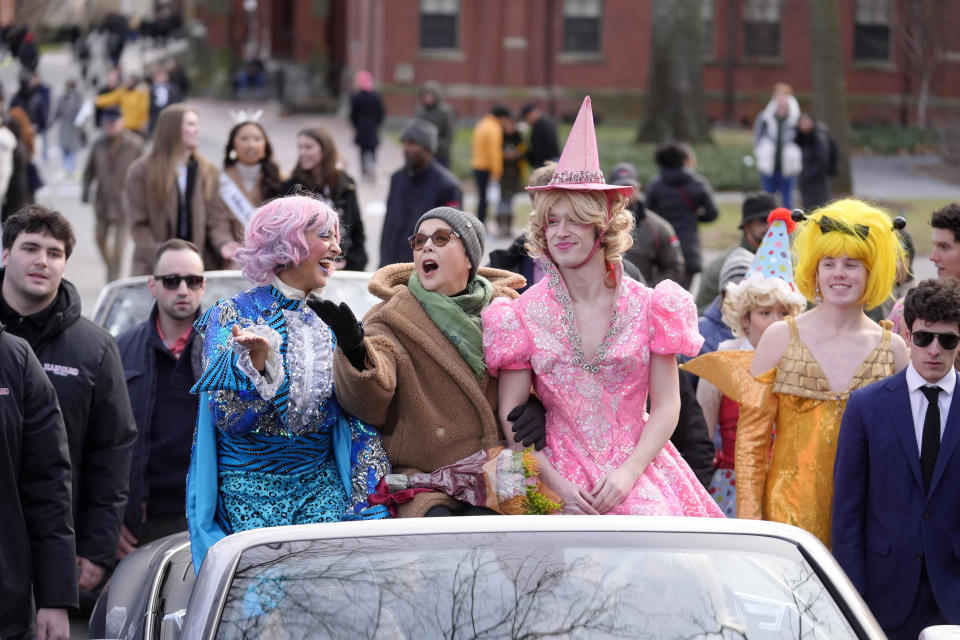 Actor Annette Bening, center, Hasty Pudding 2024 Woman of the Year, rides in a convertible with Harvard University theatrical students Nikita Nair, left, and Joshua Hillers, right, during a parade, Tuesday, Feb. 6, 2024, through Harvard Yard, in Cambridge, Mass. The award was presented to Bening by Hasty Pudding Theatricals, a theatrical student society at Harvard University. (AP Photo/Steven Senne)