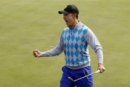 International team member Bae Sang-moon of South Korea reacts to his chip in on the 15th hole during their foursome matches of the 2015 Presidents Cup golf tournament at the Jack Nicklaus Golf Club in Incheon, South Korea, October 10, 2015. REUTERS/Toru Hanai