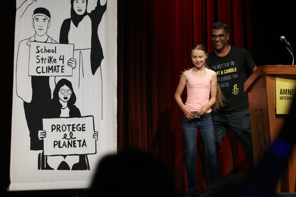 Swedish climate activist Greta Thunberg, 16, left, walks with Amnesty International Secretary General Kumi Naidoo, as she accepts the Ambassador of Conscience Award from the organization, during an event at George Washington University, Monday, Sept. 16, 2019, in Washington. The award is the organization's highest honor for human rights work. (AP Photo/Jacquelyn Martin)