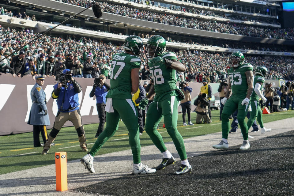 New York Jets tight end C.J. Uzomah (87) celebrates with tight end Kenny Yeboah (88) after scoring a touchdown against the Detroit Lions during the second quarter of an NFL football game, Sunday, Dec. 18, 2022, in East Rutherford, N.J. (AP Photo/Bryan Woolston)