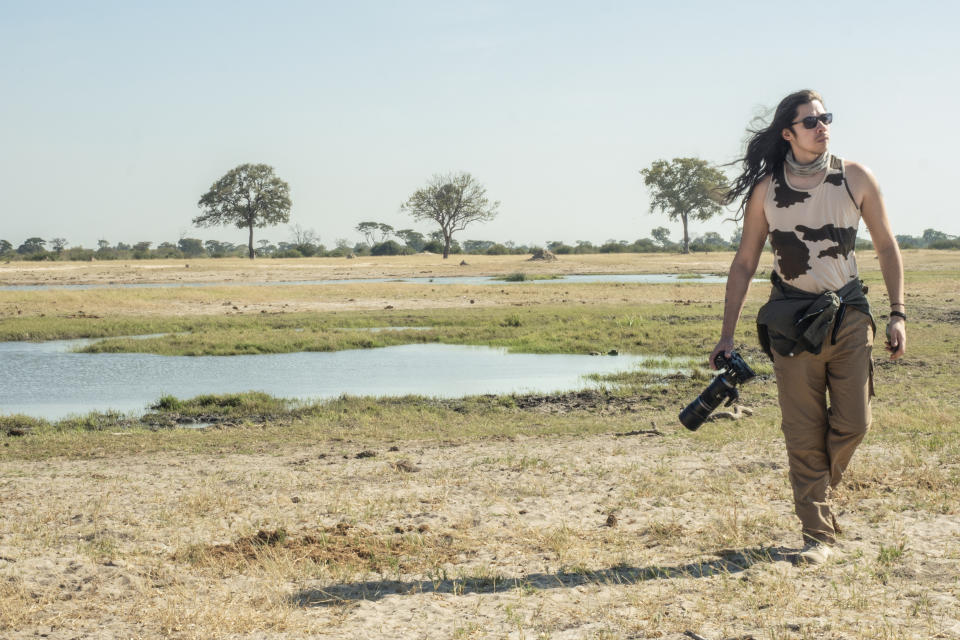 Photographer James Artaius, walking the African plain with an Olympus OM-D E-M1X in hand