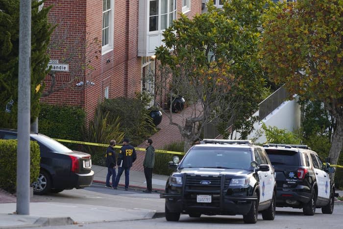 A pair of FBI agents work outside the home of Paul Pelosi in San Francisco on Oct. 28, 2022.