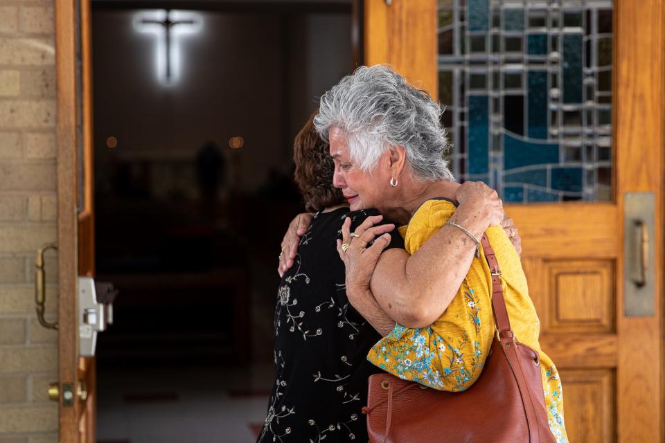 Women hug outside of Sacred Heart Catholic Church in Uvalde, Texas, before a 10 a.m. mass on May 25, 2022. 