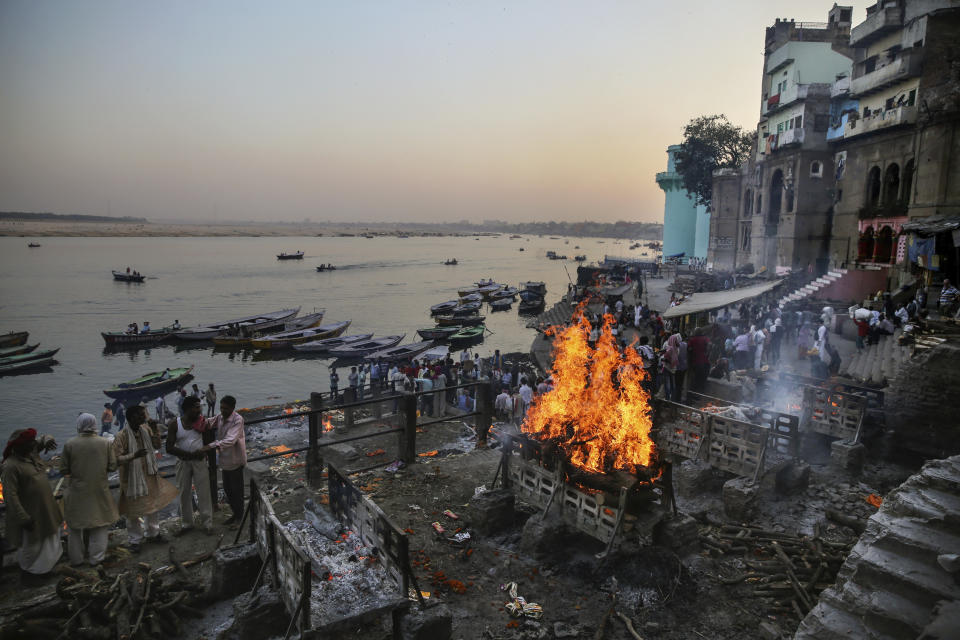 Funeral pyres burn at Manikarnika Ghat, one of the oldest and most sacred place for Hindus to be cremated, on the banks of river Ganges in Varanasi, India, Friday, Oct. 18, 2019. For millions of Hindus, Varanasi is a place of pilgrimage and anyone who dies in the city or is cremated on its ghats is believed to attain salvation and freed from the cycle of birth and death. Tens of thousands of corpses are cremated in the city each year, leaving half-burnt flesh, dead bodies and ash floating in the Ganges. (AP Photo/Altaf Qadri)