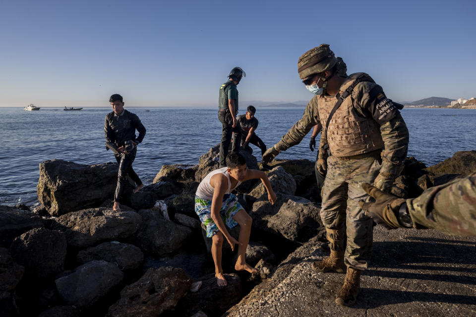 Migrants arrive at the Spanish enclave of Ceuta, near the border of Morocco and Spain, Wednesday, May 19, 2021. Spanish officials are acknowledging for the first time that the unprecedented migrant crisis has been triggered by an angry Rabat at Madrid's decision to provide medical treatment to the militant boss of the Polisario Front. (AP Photo/Bernat Armangue)