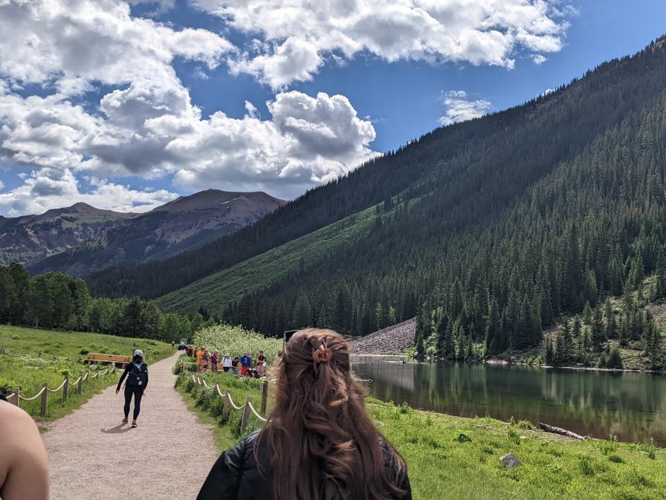 shot of the clouds in the sky over the mountains and lake in maroon bells amphitheater