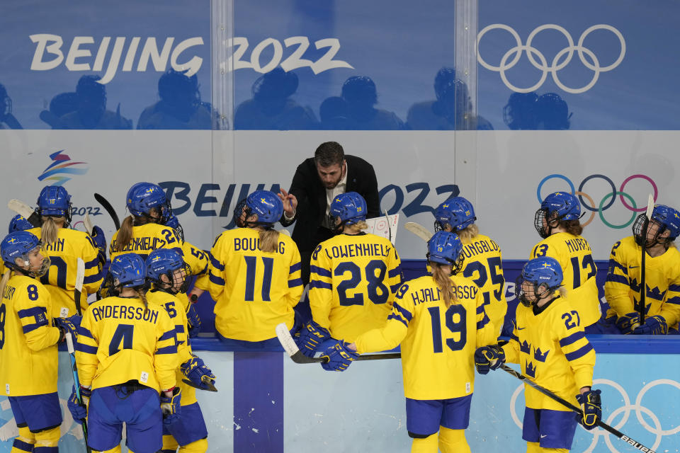 Sweden's coach Ulf Lundberg directs his team during a women's quarterfinal hockey game against Canada at the 2022 Winter Olympics, Friday, Feb. 11, 2022, in Beijing. (AP Photo/Petr David Josek)