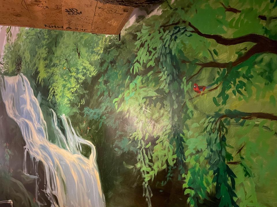 The rainforest mural in the themed-hotel room.