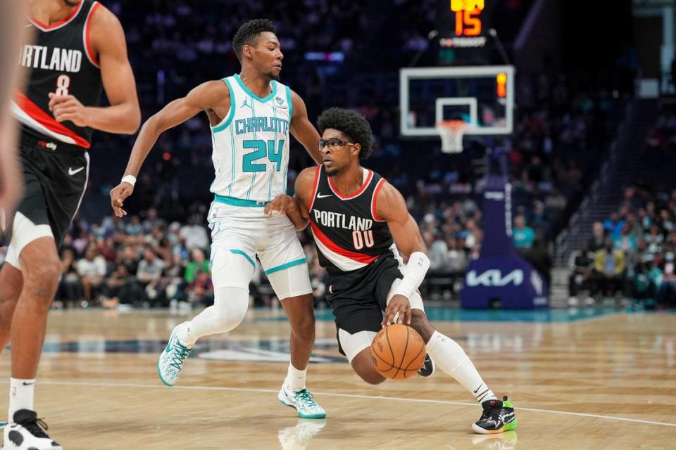 Apr 3, 2024; Charlotte, North Carolina, USA; Portland Trail Blazers guard Scoot Henderson (00) drives to the basket against Charlotte Hornets forward Brandon Miller (24) during the first quarter at Spectrum Center.