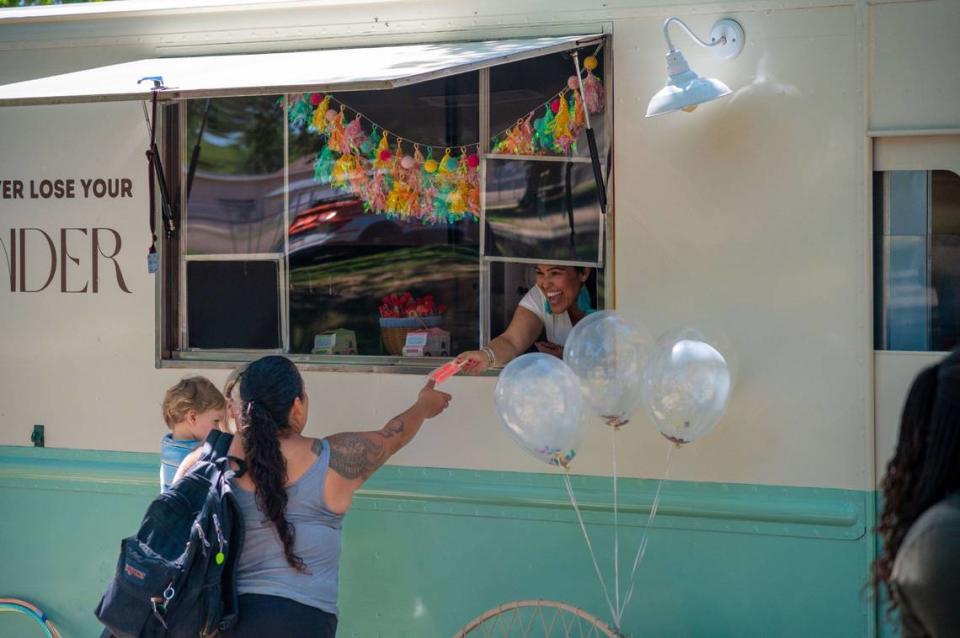 City of Refuge co-founder Rachelle Ditmore hands out a popsicle from her ice cream truck at McClatchy Park Pool in Sacramento on Friday.