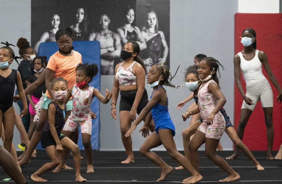 Girls participate in dance moves, Thursday, July 22, 2021, at Power Moves Gymnastics and Fitness in Cedarhurst, N.Y. The face of gymnastics in the United States is changing. There are more athletes of color starting — and sticking — in a sport long dominated by white athletes at the highest levels. (AP Photo/Mark Lennihan)