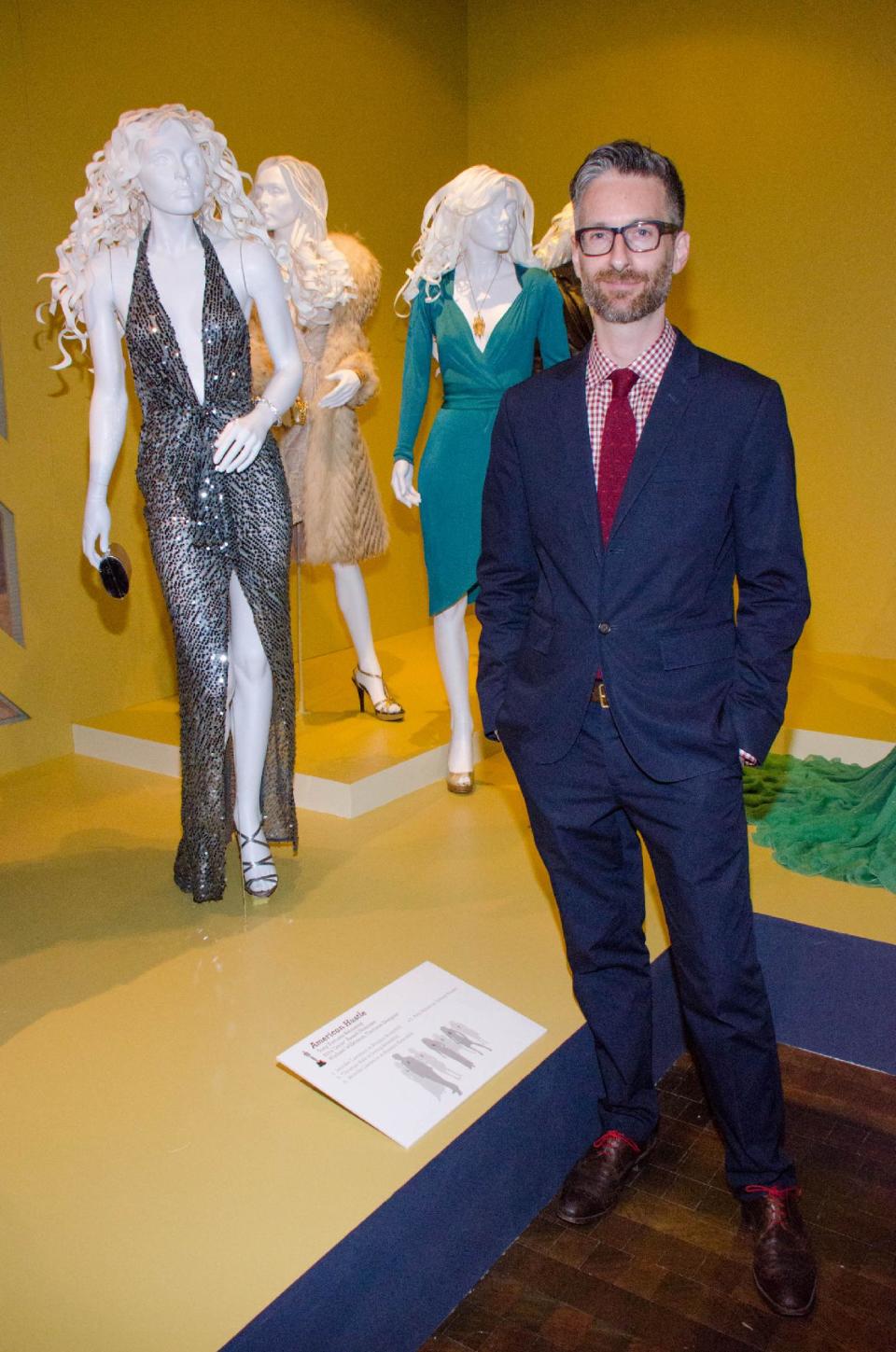 In this Saturday, Feb. 8, 2014 photo, costume designer Michael Wilkinson attends the 22nd annual Art of Motion Picture Costume Design Exhibit, in Los Angeles, Calif. Wilkinson's costumes for the film "American Hustle," are nominated for an Academy Award. The Fashion Institute of Design & Merchandising holds its free-to-the-public Art of Motion Picture Costume Design exhibit on view until April 26, 2014, featuring this year's five Oscar nominees: "American Hustle," "The Grandmaster," "The Great Gatsby," "The Invisible Woman" and "12 Years A Slave," in Los Angeles. (Photo by Tonya Wise/Invision/AP)
