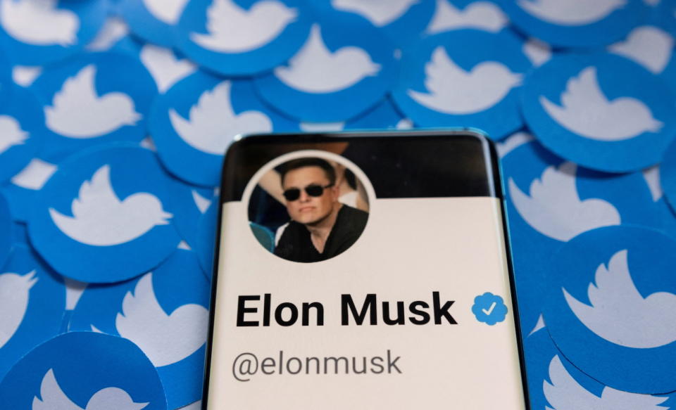 Elon Musk's Twitter profile is seen on a smartphone placed on printed Twitter logos in this picture illustration taken April 28, 2022. REUTERS/Dado Ruvic/Illustration