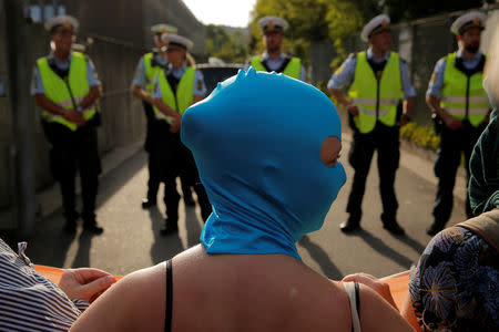 Police officers stand guard as demonstrators surround the Bellahoj Police Station as they participate in a demonstration against the Danish face veil ban in Copenhagen, Denmark, August 1, 2018. REUTERS/Andrew Kelly