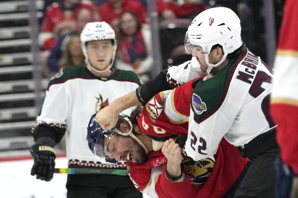 Arizona Coyotes center Jack McBain (22) throws a punch at Florida Panthers left wing Ryan Lomberg during the first period of an NHL hockey game Wednesday, Jan. 24, 2024, in Sunrise, Fla. (AP Photo/Lynne Sladky)