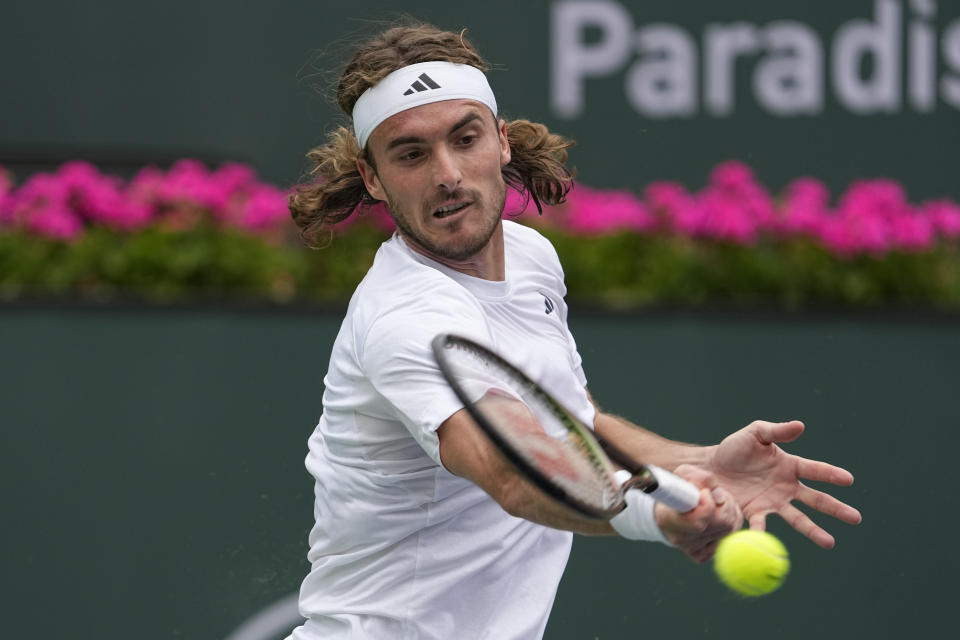 Stefanos Tsitsipas, of Greece, returns a shot to Jordan Thompson, of Australia, at the BNP Paribas Open tennis tournament Friday, March 10, 2023, in Indian Wells, Calif. (AP Photo/Mark J. Terrill)